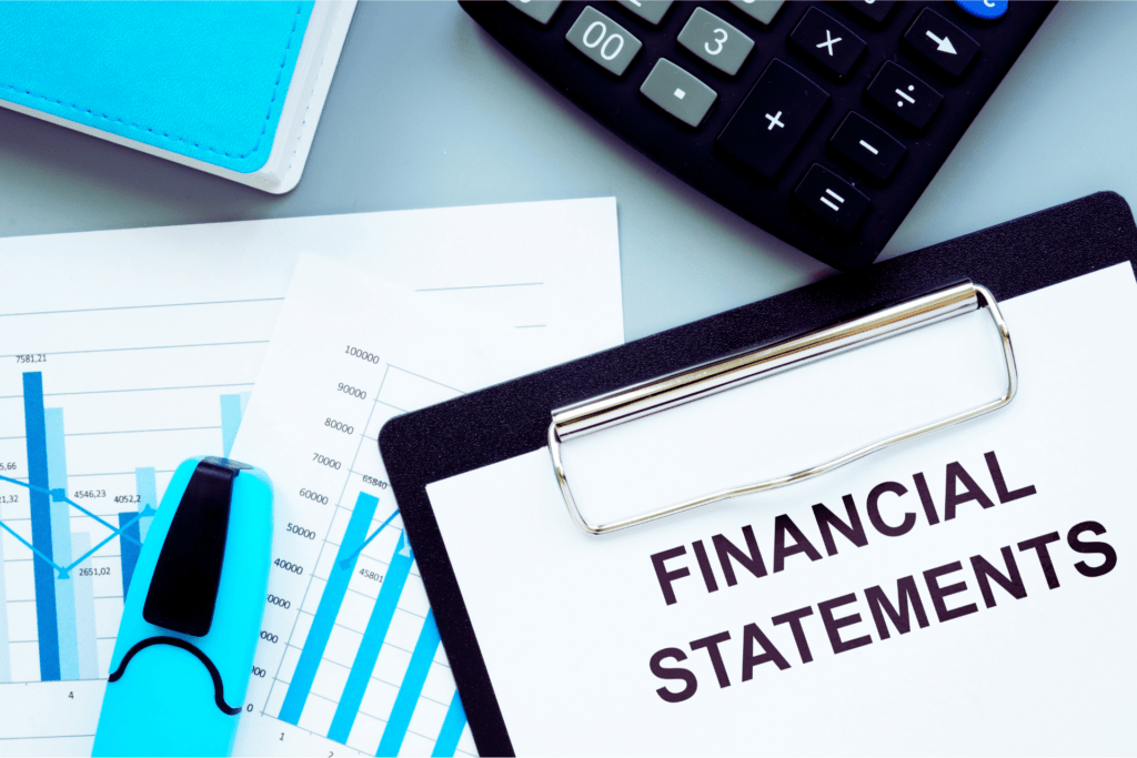 Calculator and clipboard with financial statements