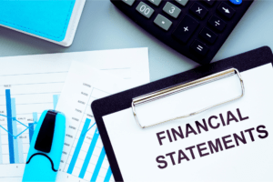 Calculator and clipboard with financial statements